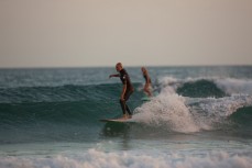 Surfers ride waves on a bank at Main Beach, Mount Maunganui, New Zealand. 