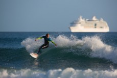 A surfer turns on a wave at Main Beach, Mount Maunganui, New Zealand. 