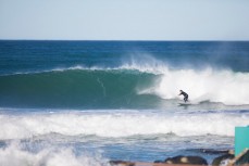 A surfer rides a clean wave at St Clair Point, Dunedin, New Zealand. 