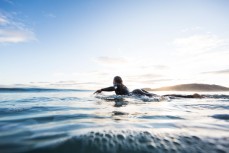 Surfer Christine Funck paddles out into calm clean conditions at Aramoana, Dunedin, New Zealand. 