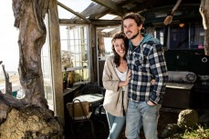 Singer songwriter Joe Wilson with his partner Evie Hall, and dog Ziggy in their house bus parked above Whareakeake, Dunedin, New Zealand. 