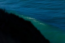 Waves break off a cliff headland during a large winter swell at St Clair, Dunedin, New Zealand. 