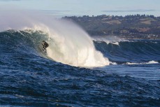 Joe Dirt hugs the wall during a session at a remote reefbreak near Dunedin, New Zealand.